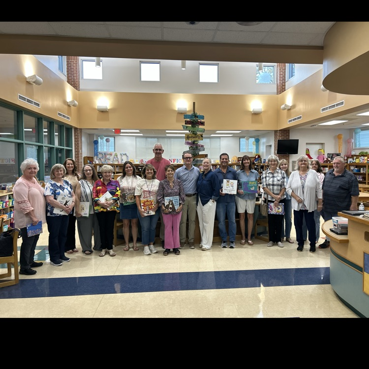 Grandparents holding the books that are going to read to homerooms around East End.