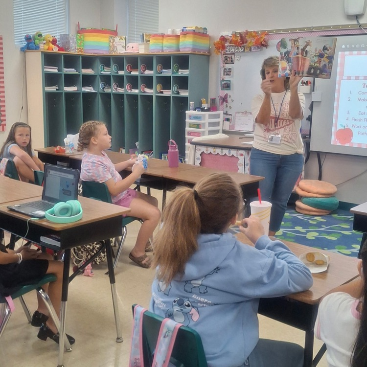 Students in Ms. Gibson’s third grade class listening to a special grandparent reader