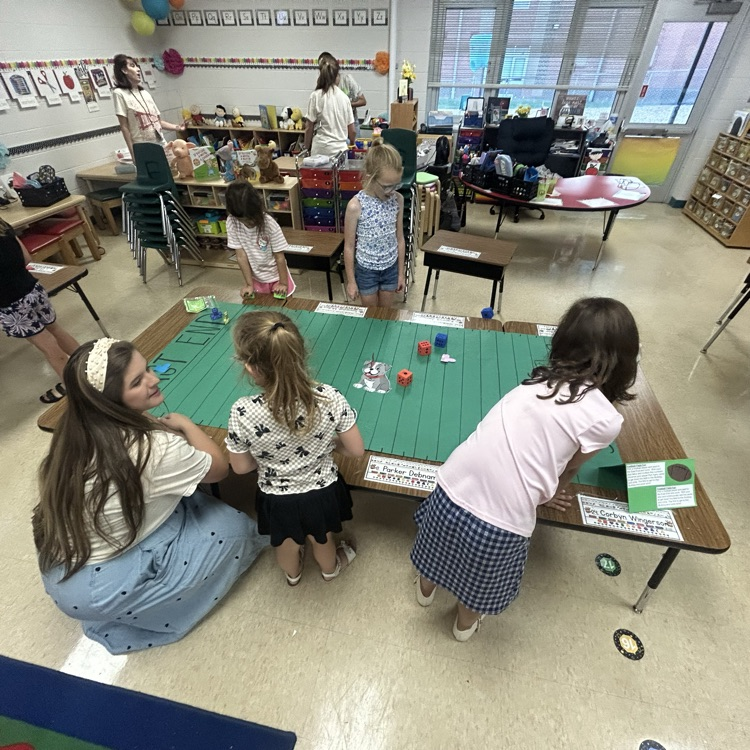 Our Bulldogs working with Mrs. Richardson on a math game