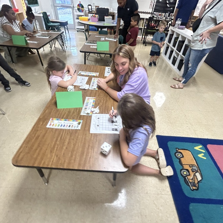 Mrs. Timmerman helping students with a math game
