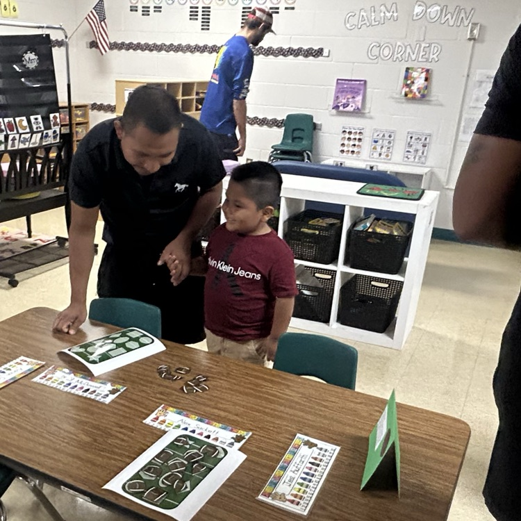 Our PreK students are matching football shapes with parents