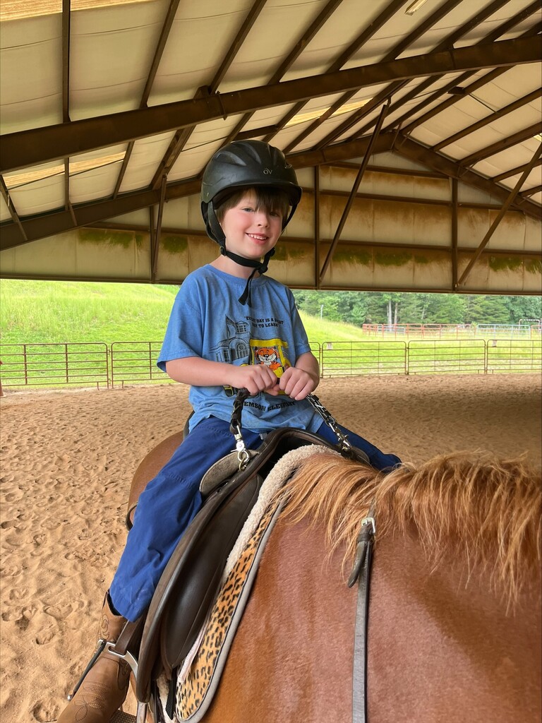 Student riding horse at Happy Hooves.
