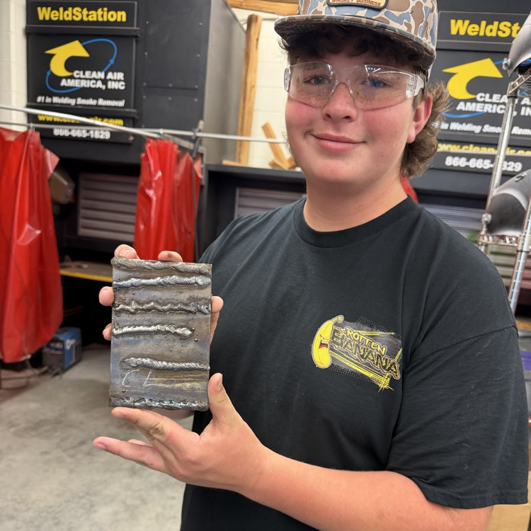 picture of PMS student holding a welding project at the Career Center