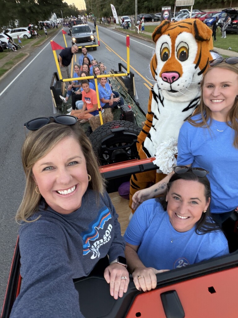 Clemson Elementary teachers, staff and Stripes on the homecoming parade float.