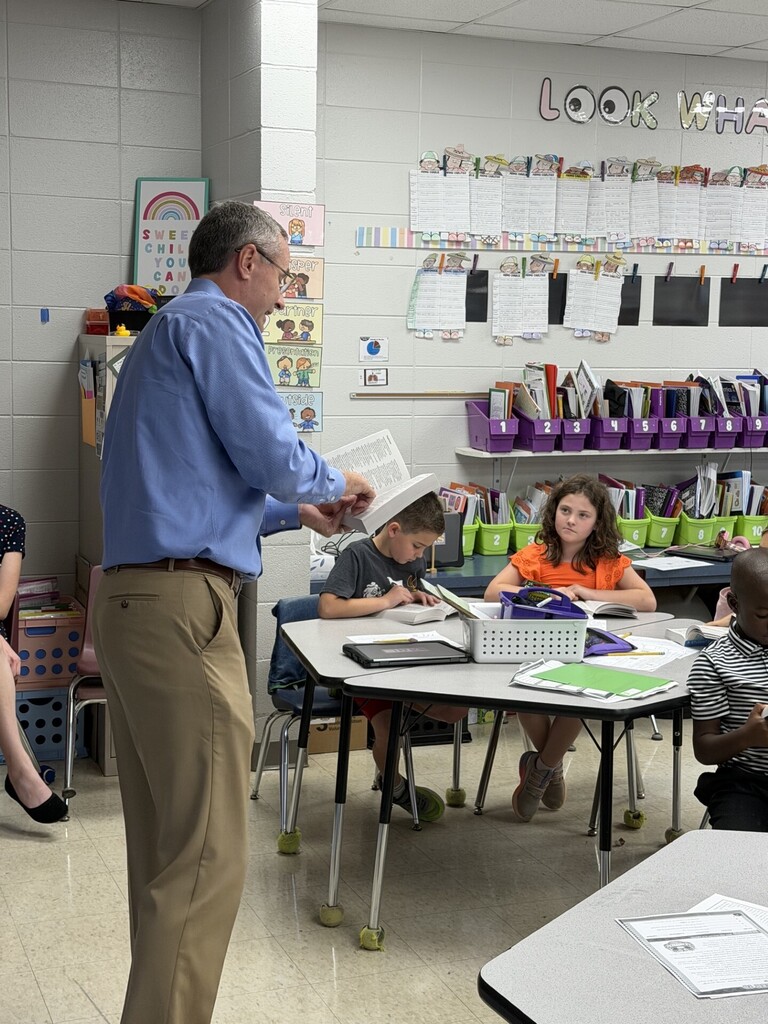 Rotarian and students looking up the definition of fun.