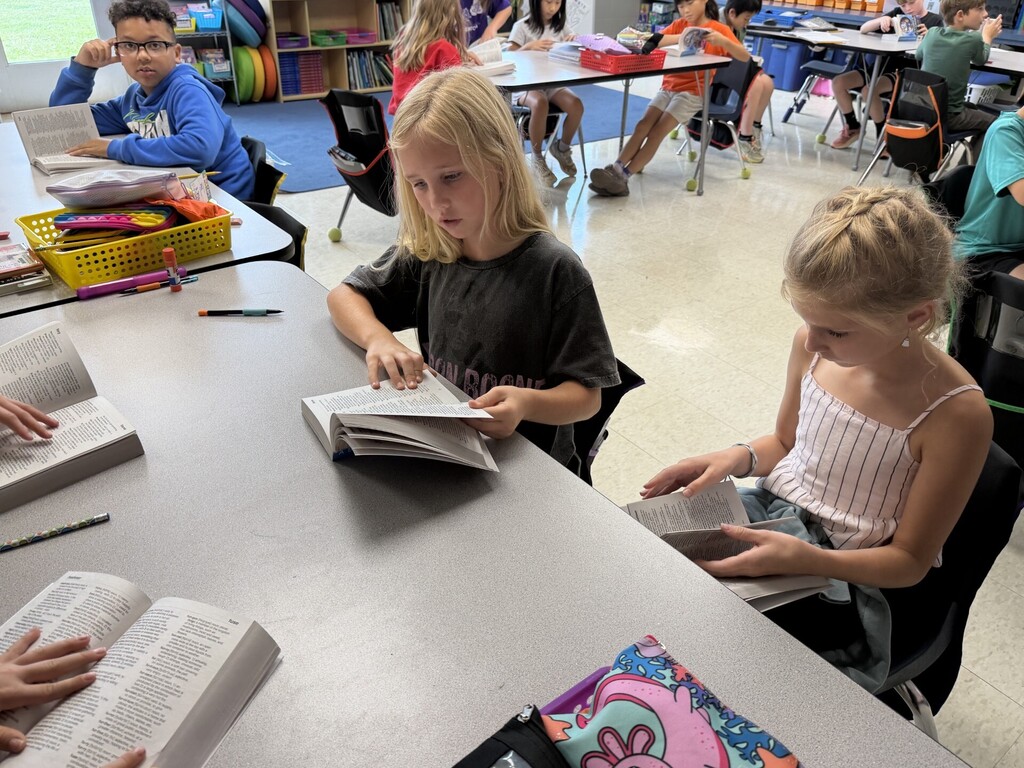 Students looking through dictionaries