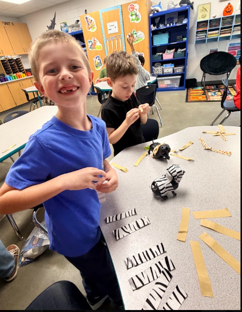 Student learning about the purpose of animal fur and covering his robotic dog with pretend fur