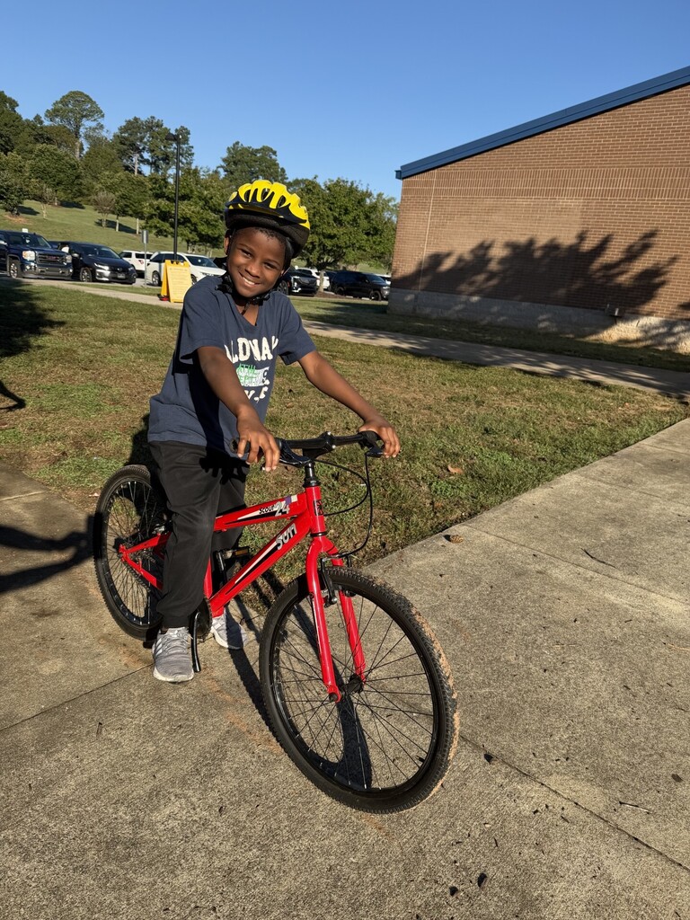 Fourth grade student on a bike.