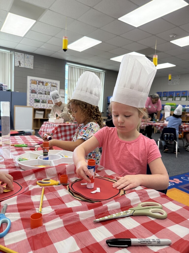 Students gluing pizza together