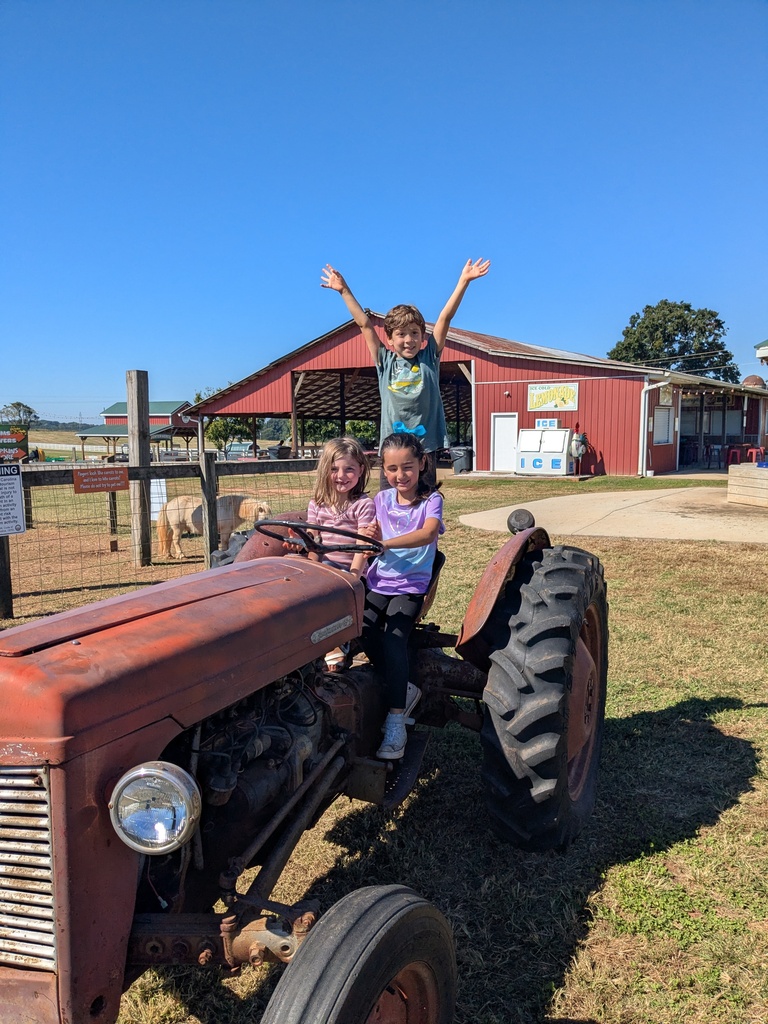 students pose on the tractor 