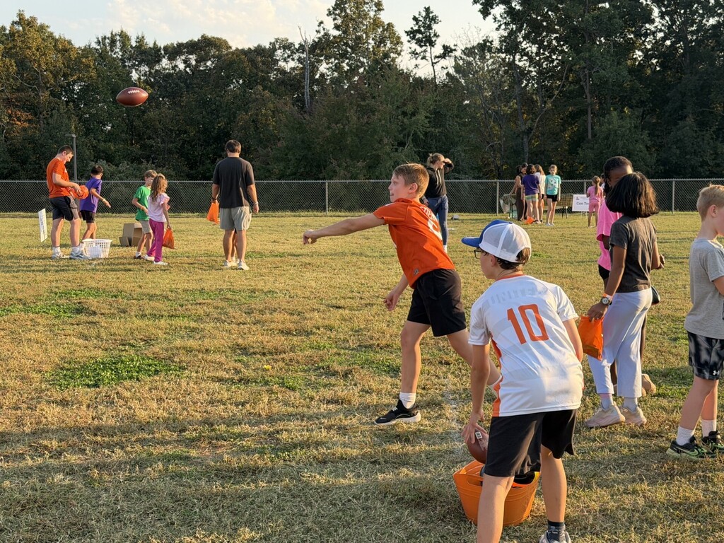 Fifth grade students participating in a football throw.