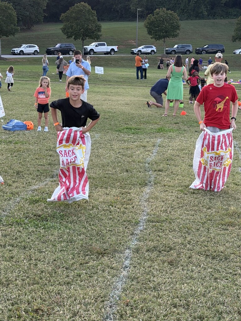 Students participating in a sack race at the fall festival.