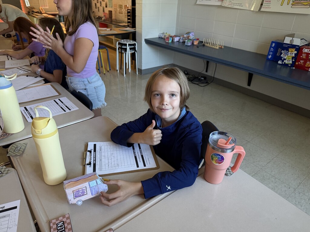 Student having a successful food truck business at the 5th grade math Food Truck Festival.