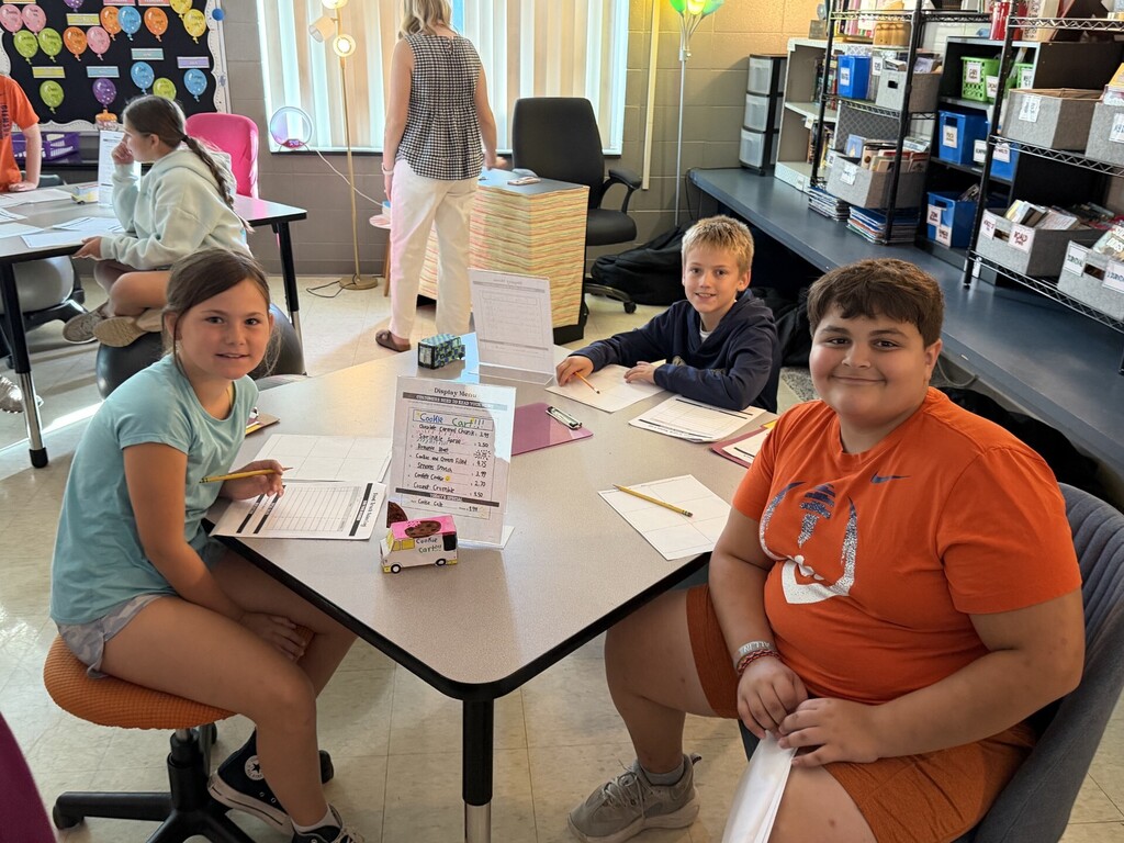 Fifth grade students setting up their food trucks to sell items to their customers.