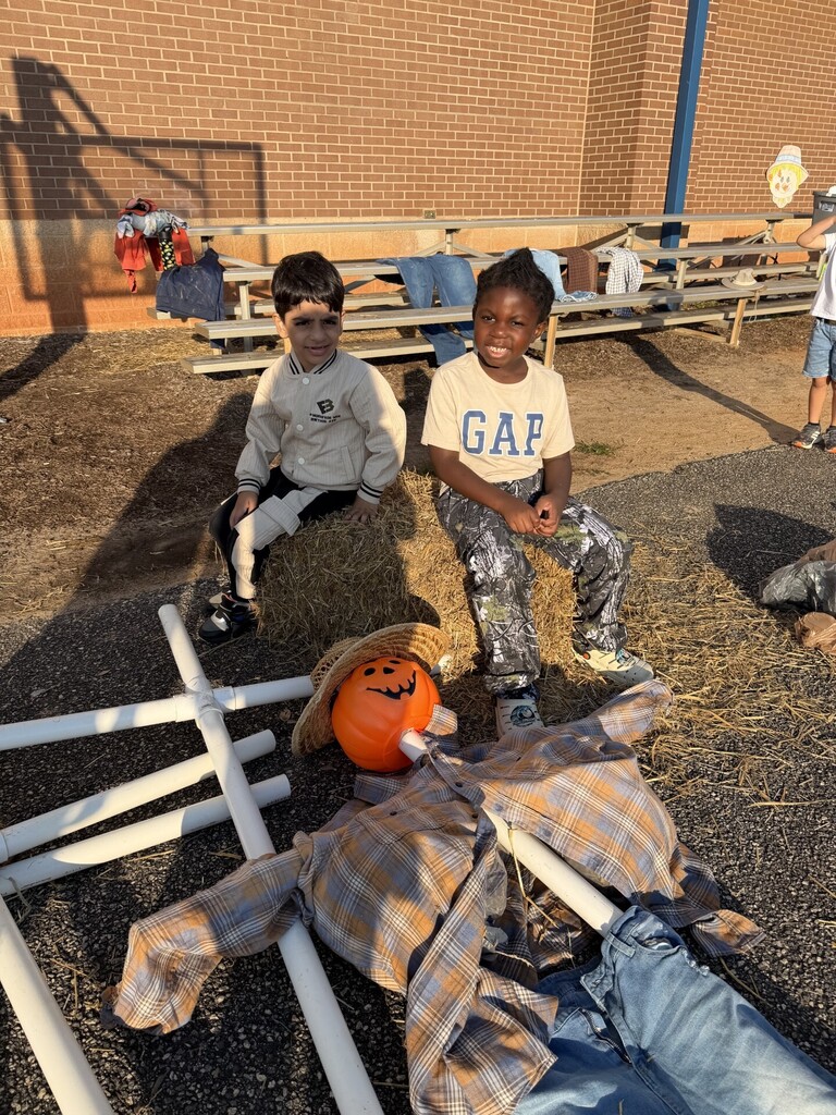 Students stuffing their scarecrow.