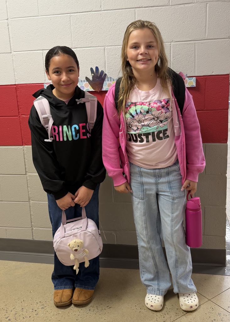 5th grade girls pose in their pink