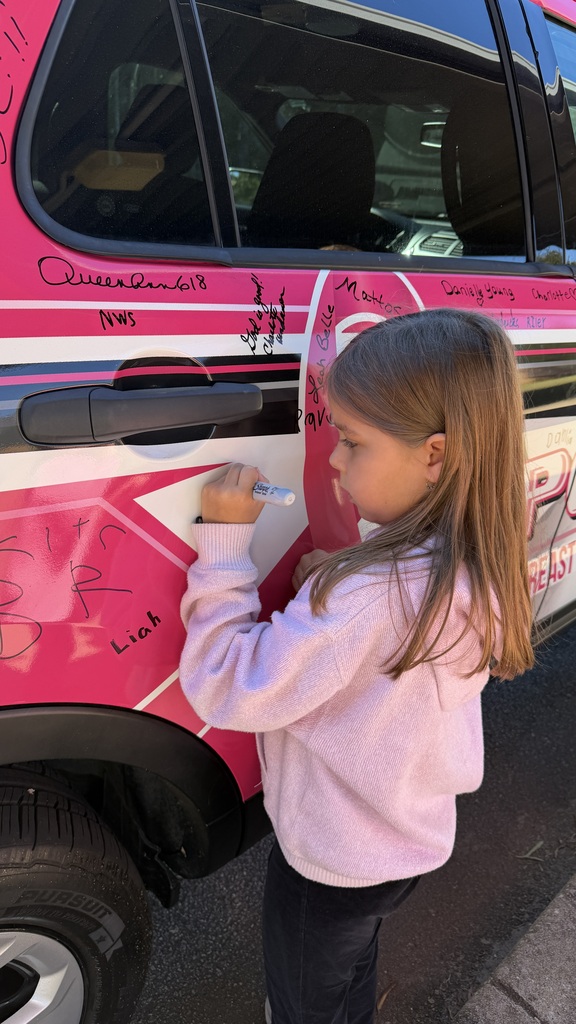 first grade students signs the car