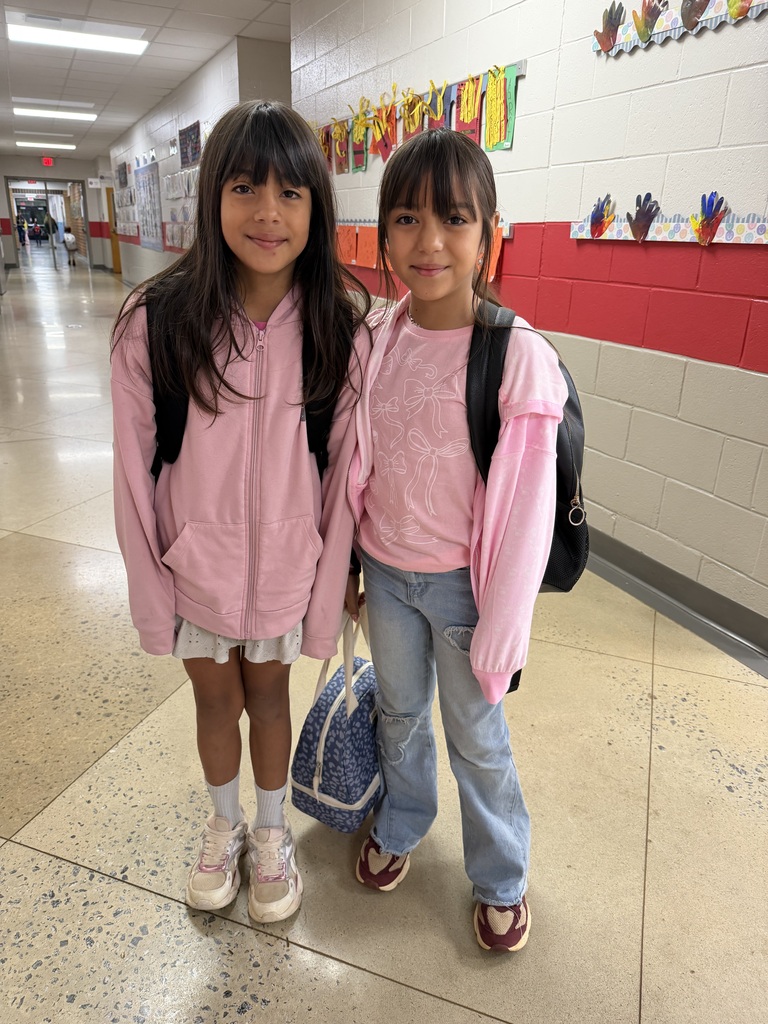 students pose in their pink