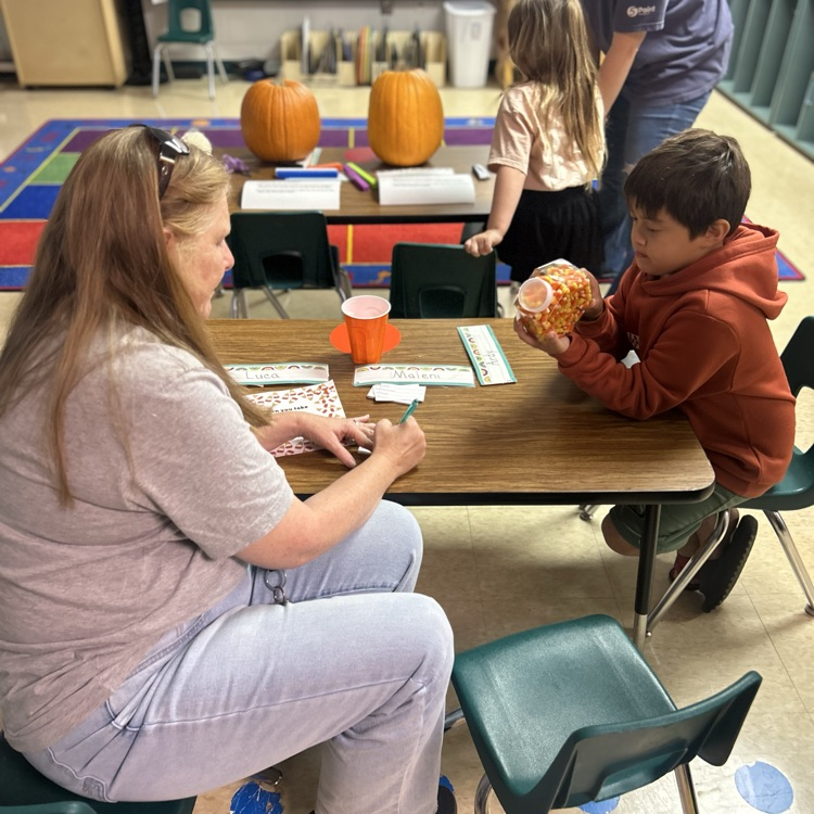 a student estimating the amount of candy corn in the jar