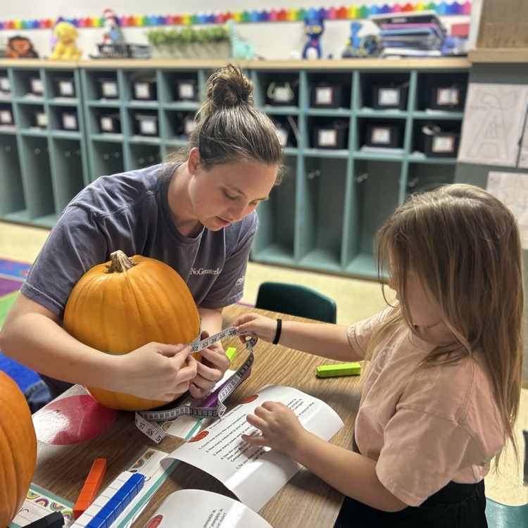 A student and her parent completing pumpkin investigations