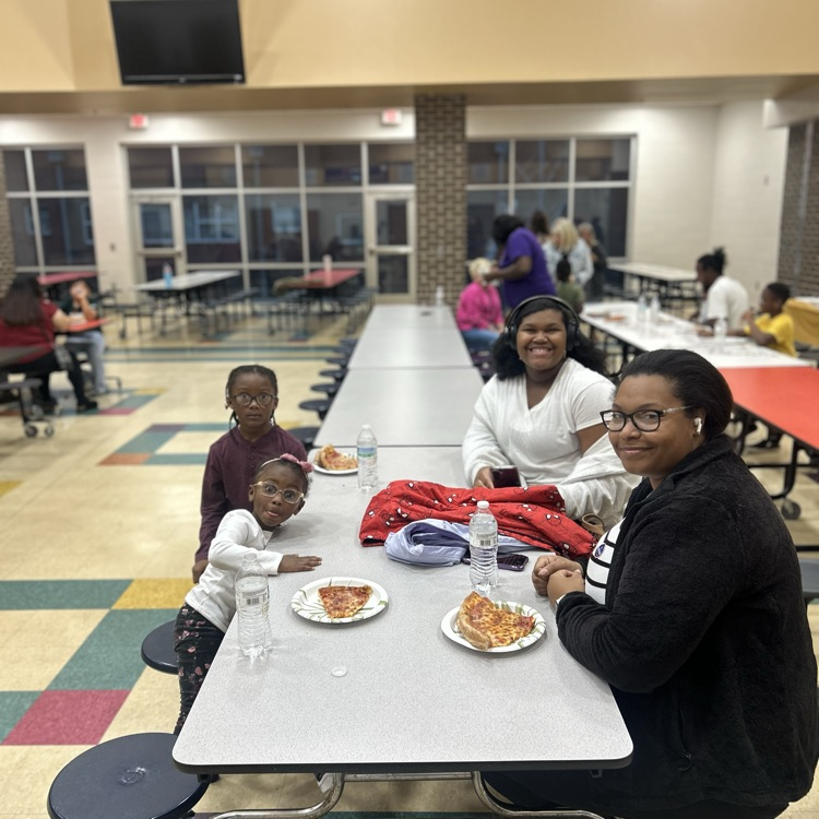 a family eating pizza together