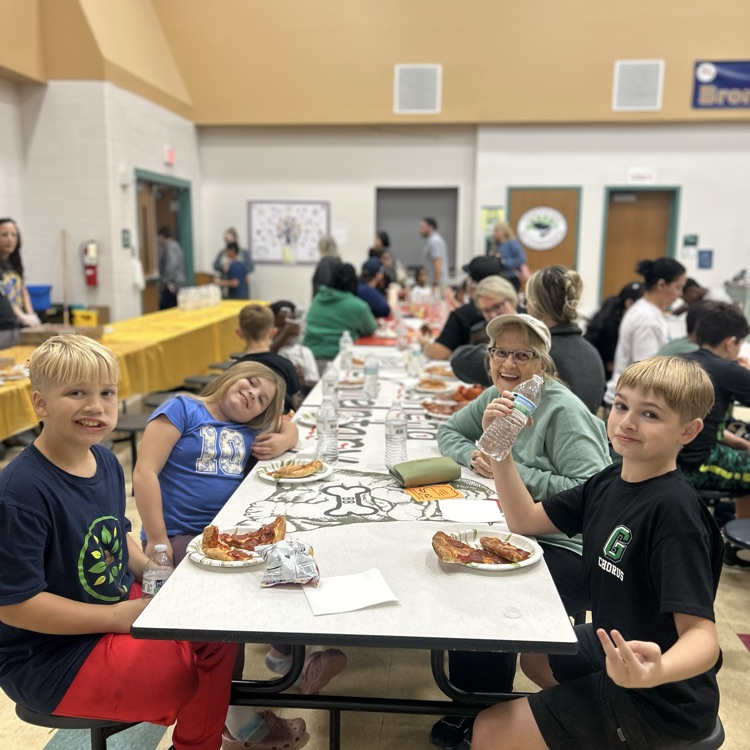 a family enjoying pizza at family night 