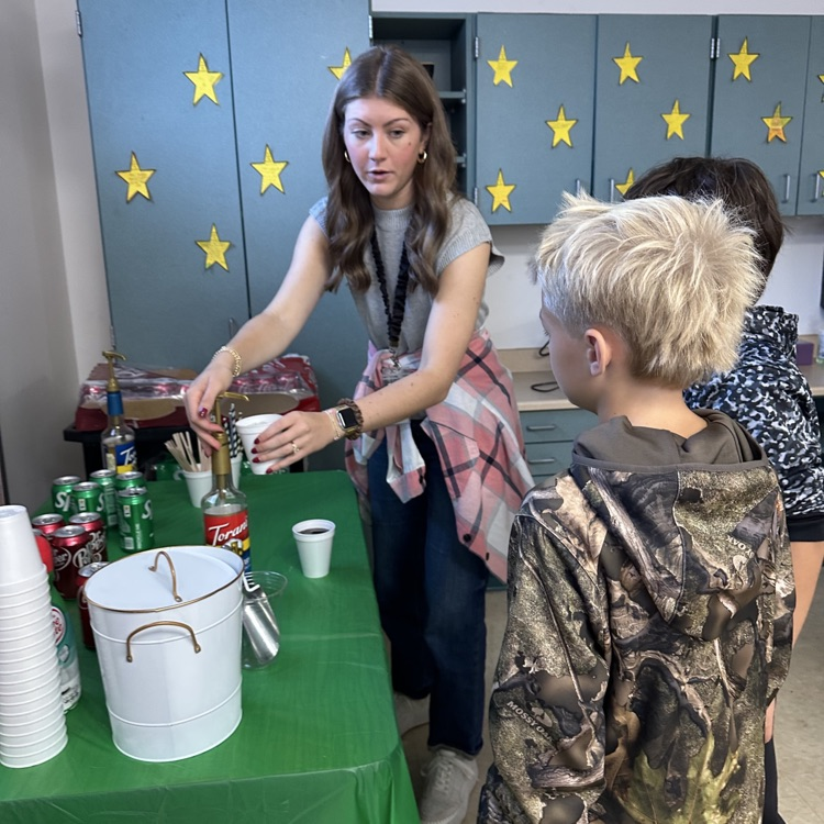 Mrs. Whitfield helping two students with the Dirty Soda Cafe!