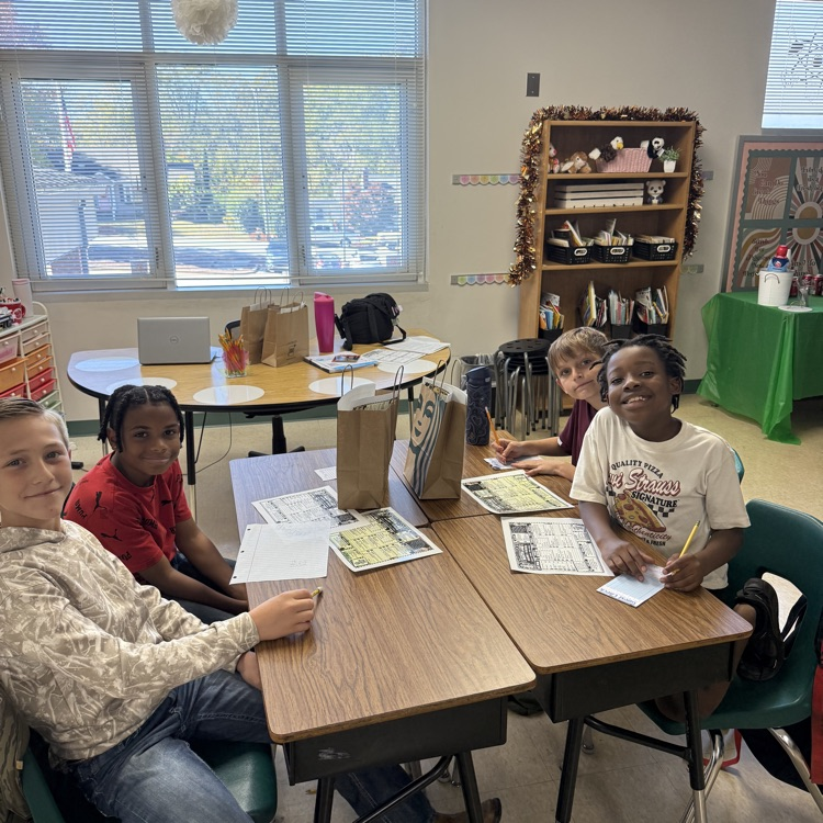 a group of fifth graders working hard to complete activities for the dirty soda cafe