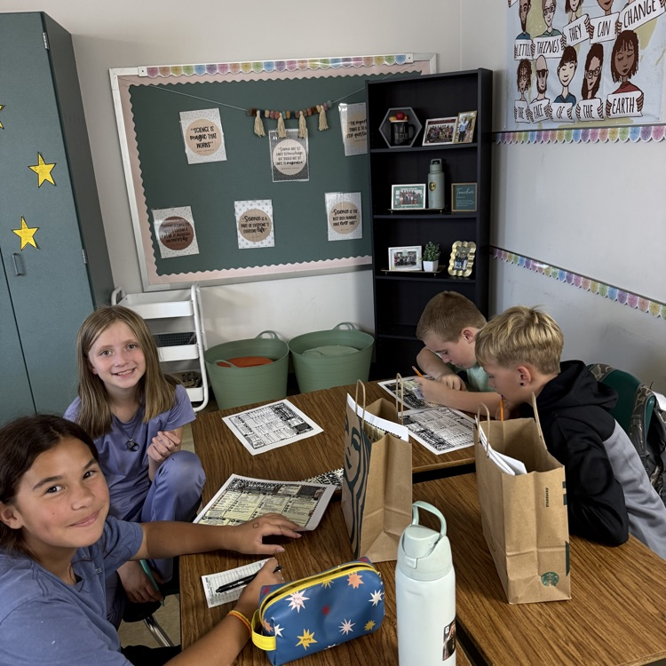 Four students working on solving problems for the dirty soda tasks