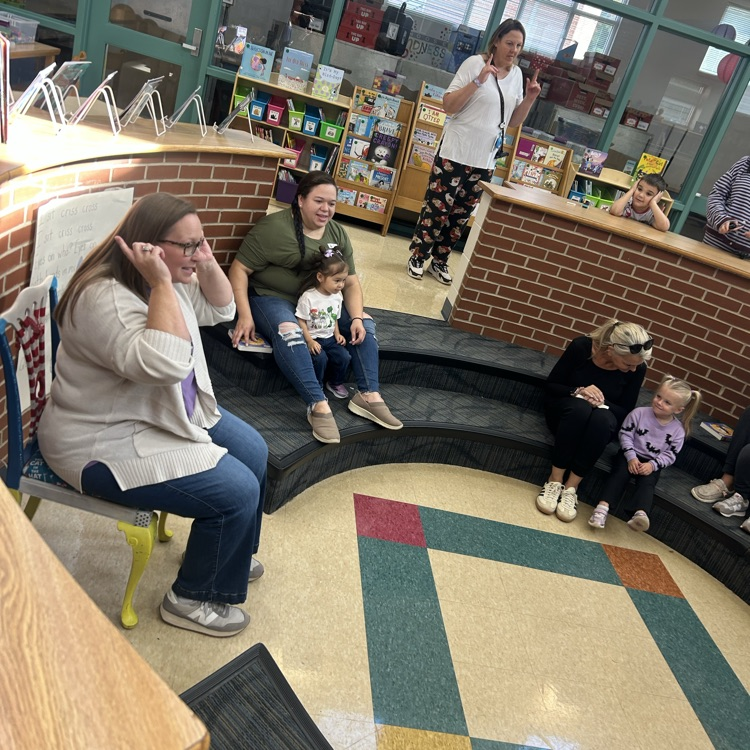Mrs. Lively singing to a group of preschoolers