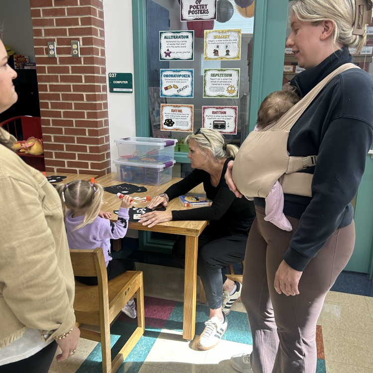 A parent and child making a letter b bay during pup 