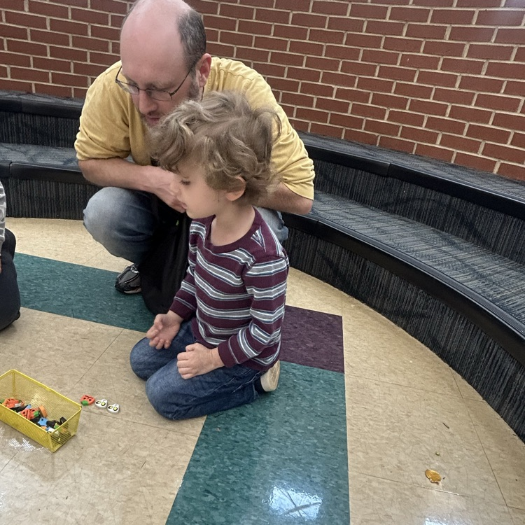 A parent and child making patterns during pup 