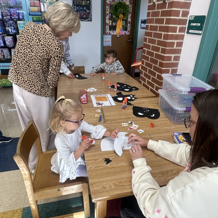 A parent and child making a letter b bat during pup tales