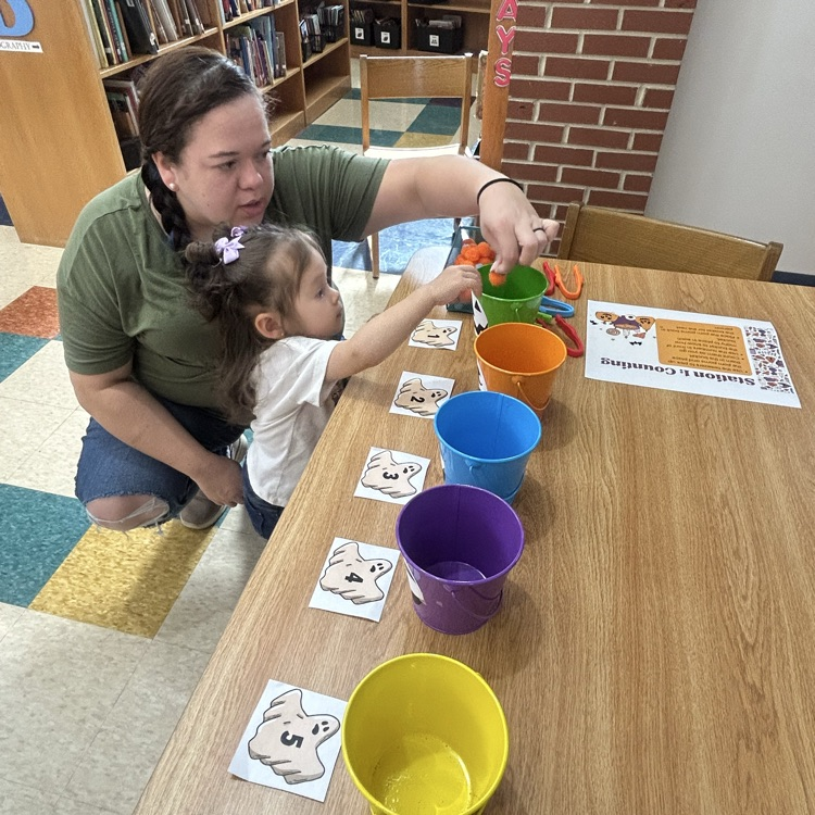 A parent and child counting during pup 