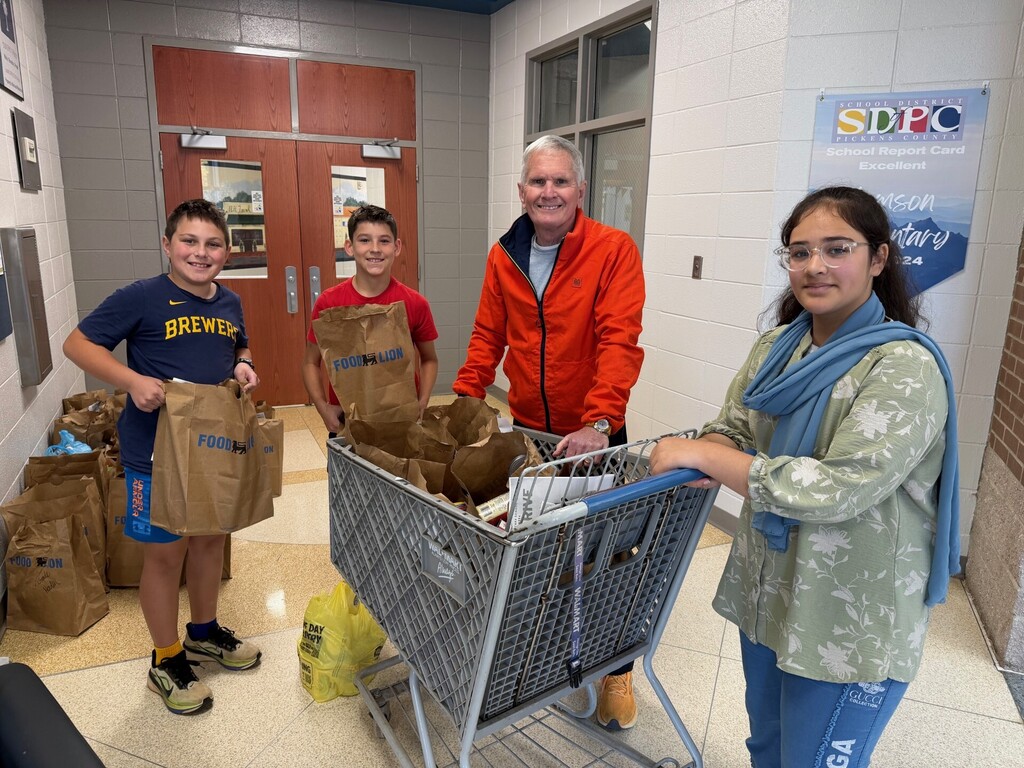 Students and CCC volunteer loading up all the donations of food for CCC.