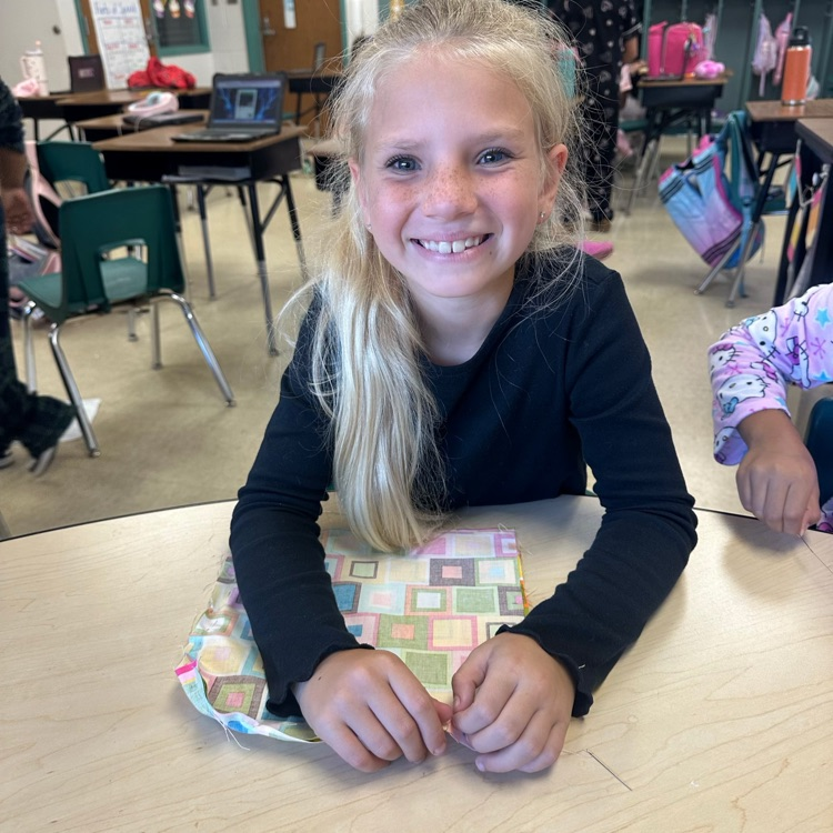 students dressed in pjs for read ribbon week are sewing pillows to go with their text