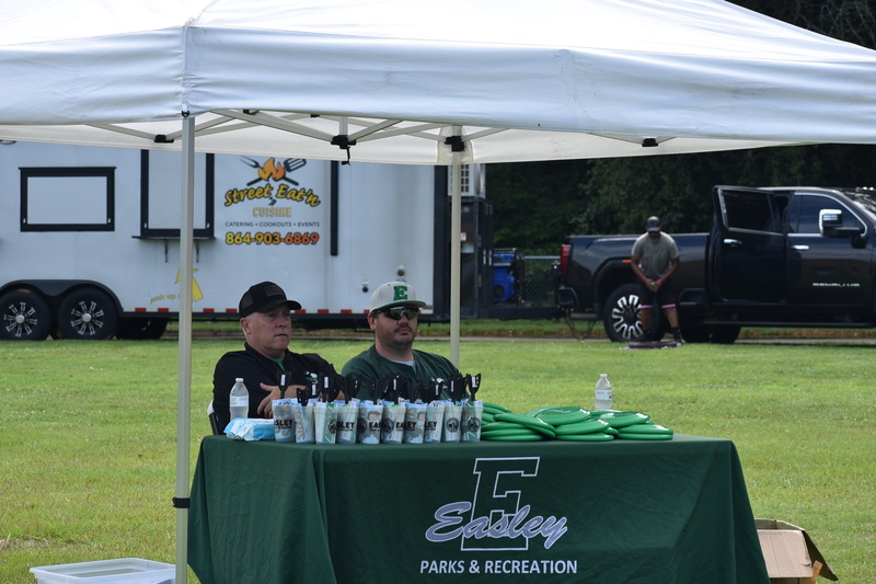 Image of the Easley Parks & Recreation table preparing to serve students for the Shark Signing Day event. 