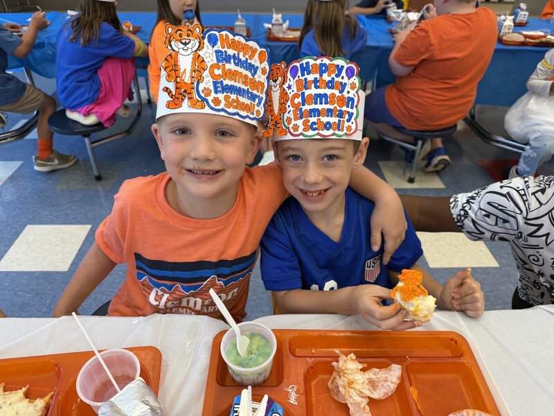 Students at birthday clelebration lunch eating their cupcake