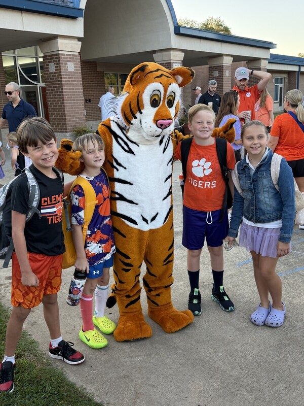 Clemson Elementary Students posing with Stripes at Walk and Roll to School