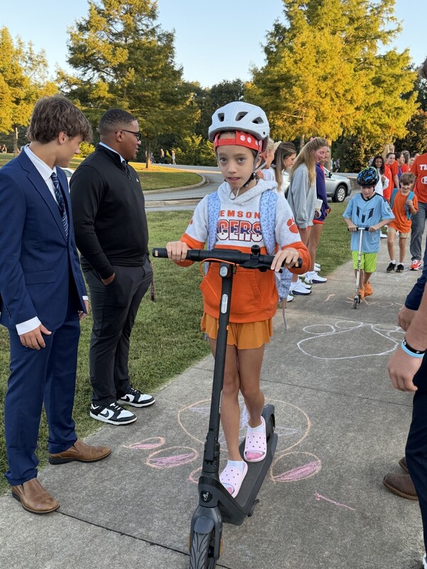 Student riding a scooter to school