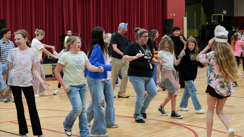 Students and teachers dancing during Hispanic Heritage assembly