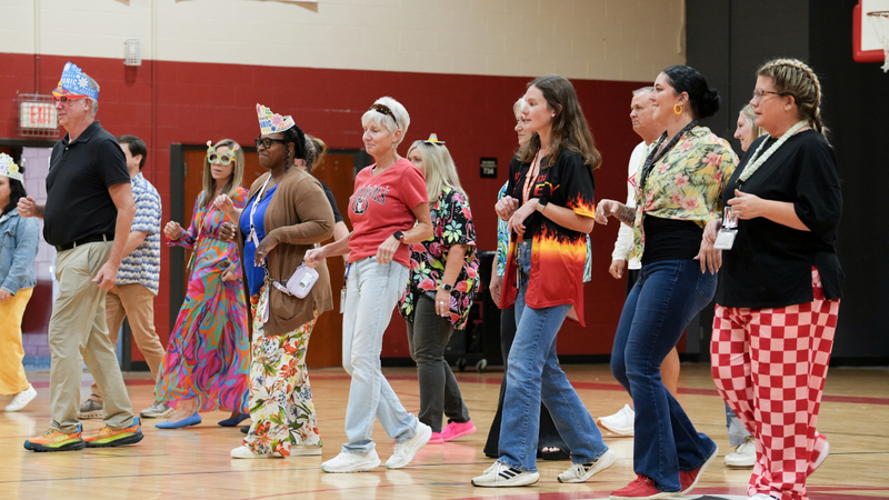 Teachers salsa dancing at Hispanic Heritage assembly