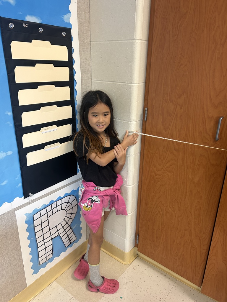 One student measuring cabinets 