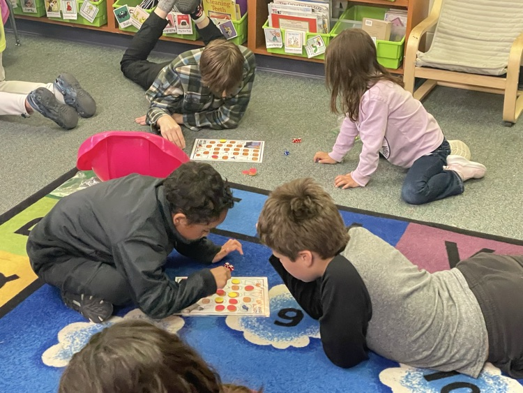 first and fifth grade boys playing a math game. 