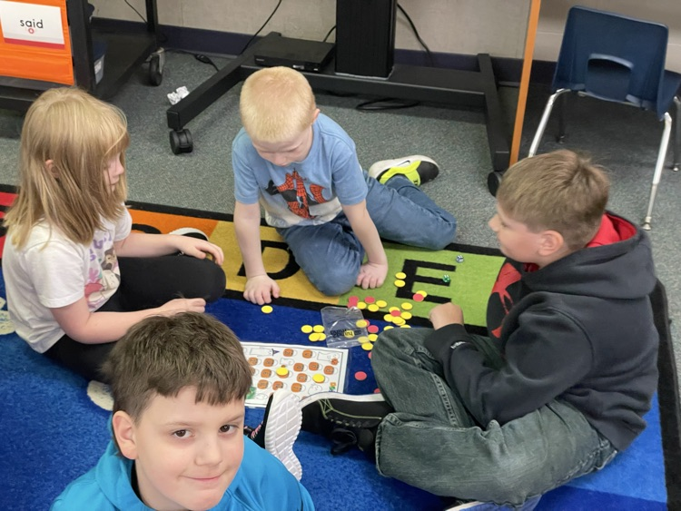first and fifth grade boys playing a math game. 
