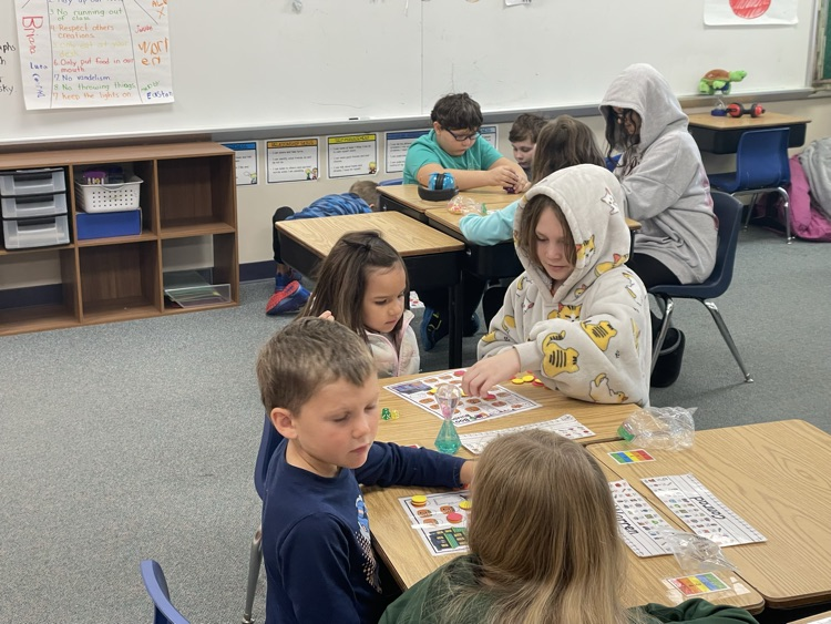 first and fifth grade boys playing a math game. 