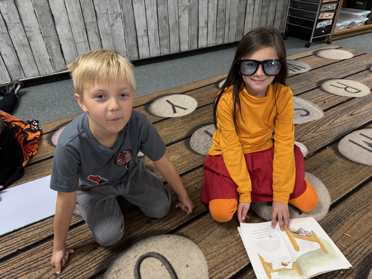 1st graders reading together in costumes