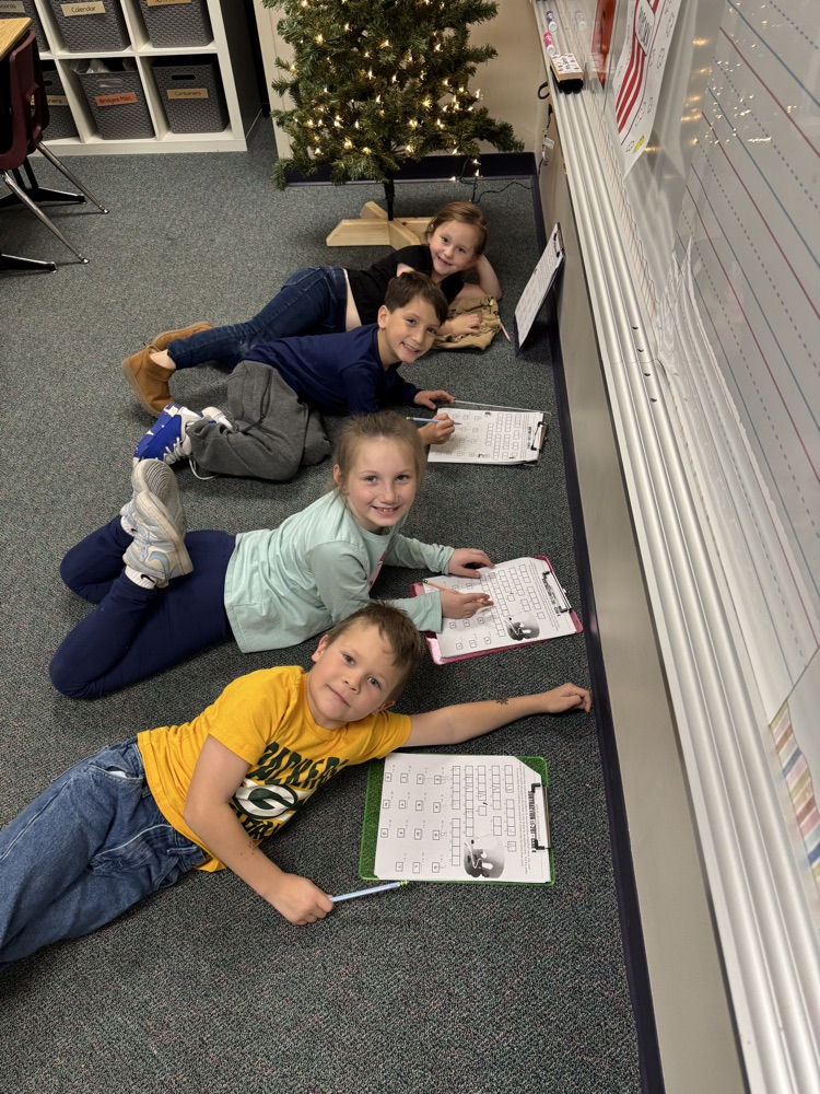 first grade students solving math problems together 