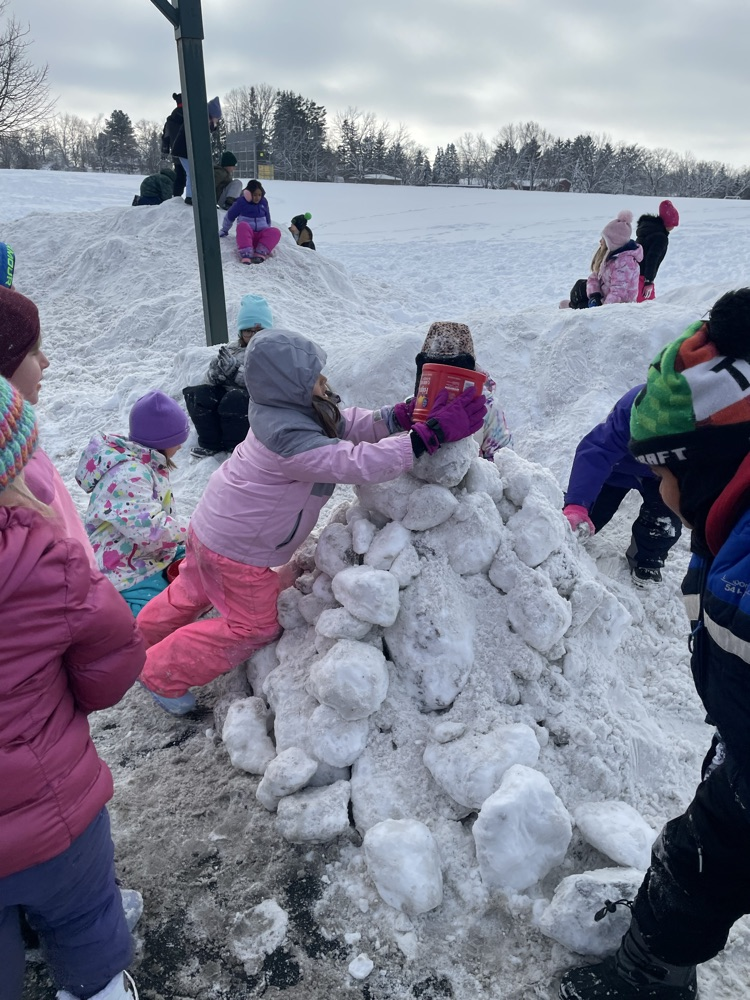 1st graders building a snow mountain.
