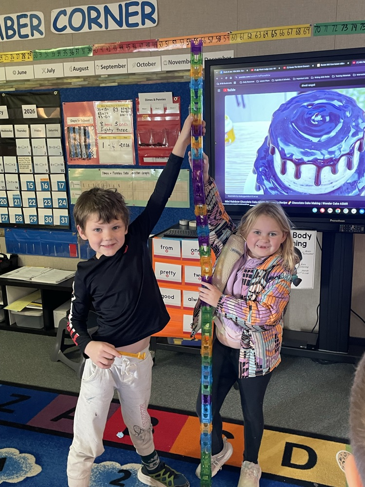 One first grade boy and one first grade girl building a tower
